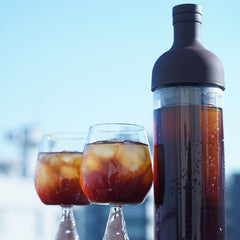 Hario Filter In Cold Brew Coffee Bottle Standing Next To Glasses