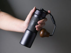 1Zpresso K-Ultra manual hand grinder in a hand