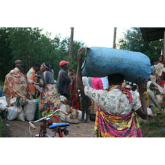 Burundi coffee producer transporting beans from Munkaze Washing Station