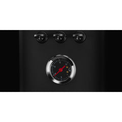 Close-up of the analogue pressure gauge on the black Gaggia Classic UP espresso machine.