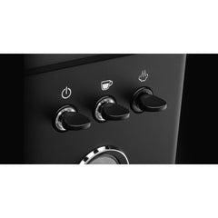 Close-up of the Gaggia Classic UP power, brew and steam toggle switches.