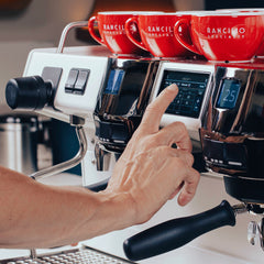 Rancilio Invicta espresso machine touchscreen with espresso cups