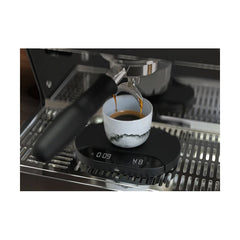 Mahlkonig Sync Scale black electronic scale used under an espresso grouphead with cup