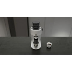 White Mahlkönig X64 SD espresso grinder on counter with funnel and espresso cup