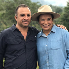 Coffee producers Moisés Herrera and Marysabel Caballero standing together outdoors