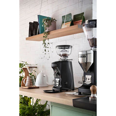 Black Mazzer Mini Compact espresso grinder on café bar