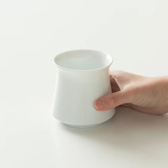 White Origami Harmony Cup with hand