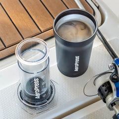 AeroPress Go Plus coffee press next to brewed coffee in tumbler