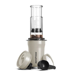 AeroPress Go Plus cream coffee press on tumbler with accessories