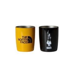 Yellow The North Face cup and black Bialetti cup with silver-coloured interiors.