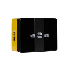 Closed black and yellow Bialetti x The North Face Adventure Set gift case with a co-branded sleeve.