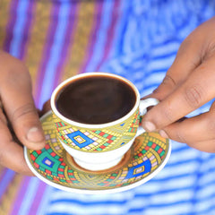 Full cup of coffee held by hands