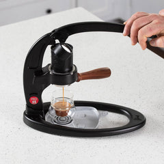 Flair 49 PRO Espresso Maker lifestyle shot with hand and espresso glass
