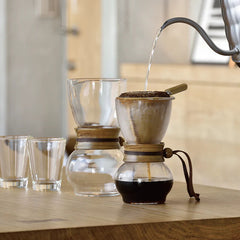 Water pouring into Hario Drip Pot Woodneck coffee brewer