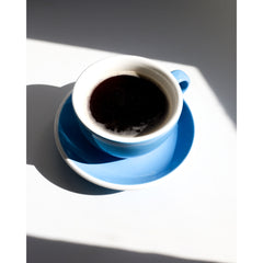 Black coffee inside ACME Classic Cappuccino Kokako cup with saucer