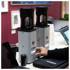 Nucleus Link Roaster in operation with arm reaching to button