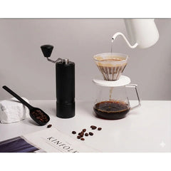 Nuttii X Timemore Goosey Hand Grinder 38mm Black pour-over scene with coffee brewer & newspaper