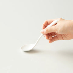 White Origami ceramic cupping spoon in hand