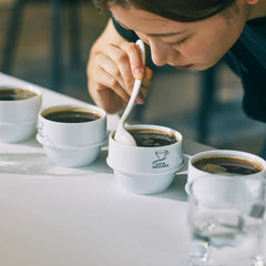 Origami ceramic cupping spoons used to break coffee crust