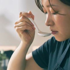 White Origami ceramic cupping spoon used to taste