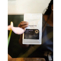 Rosetta Roastery barista holding a bag of Peru Aromas Del Valle Washed