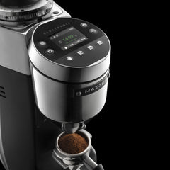 Mazzer Super Jolly g dispensing ground coffee into a portafilter, with the dose weight shown on the display.