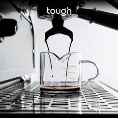 Tough Double Spout Espresso shot glass with espresso dripping into it from portafilter