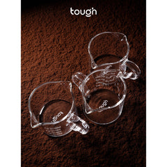 Three Tough Double Spout Espresso shot glasses with coffee grounds underneath