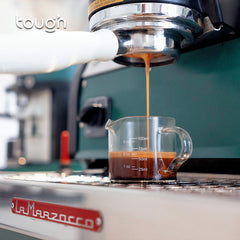 Tough Double Spout Espresso shot glass underneath espresso machine grouphead with coffee pouring