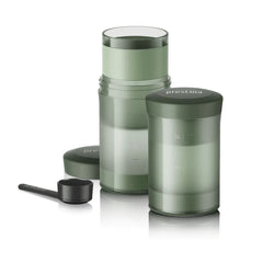 Wacaco Prestina with its cup removed, showing the brewing chamber, caps and coffee scoop.